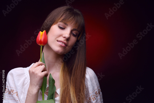 young pretty woman holding tulip