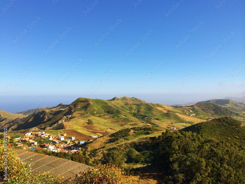 Green rural hilly landscape and clear sky