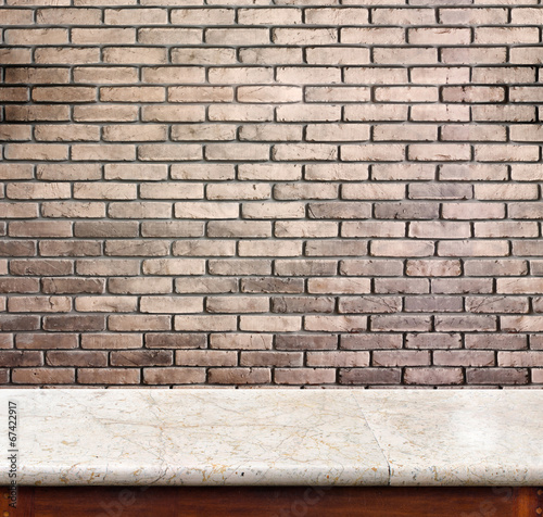 Empty marble table and brick wall in background. product display