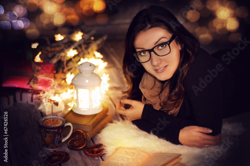 girl reading a book at home on christmas photo