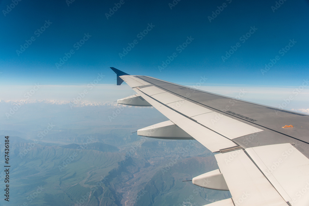Airplane wing out of window Airplane wing out of window