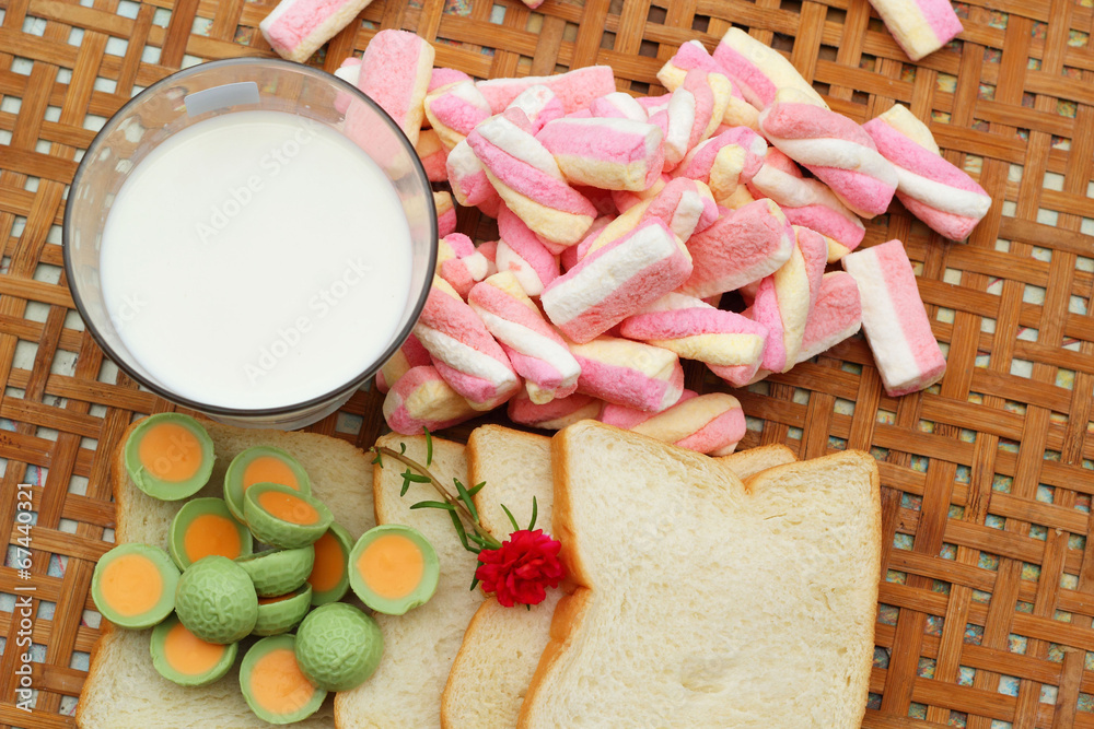 fresh milk and pink marshmallows with a slice of bread. fresh milk and pink marshmallows with a slice of bread.