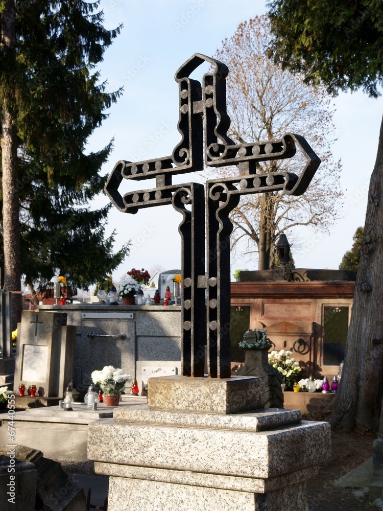 metallic cross on tomb of cemetery in Jaslo