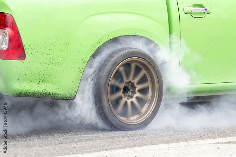 race car burns rubber off its tires in preparation for the race race car burns rubber off its tires in preparation for the race