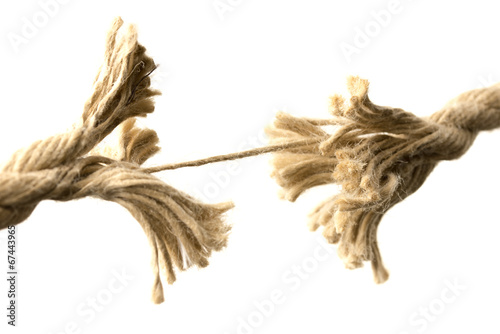 Rope splitting apart held together by one thread photo