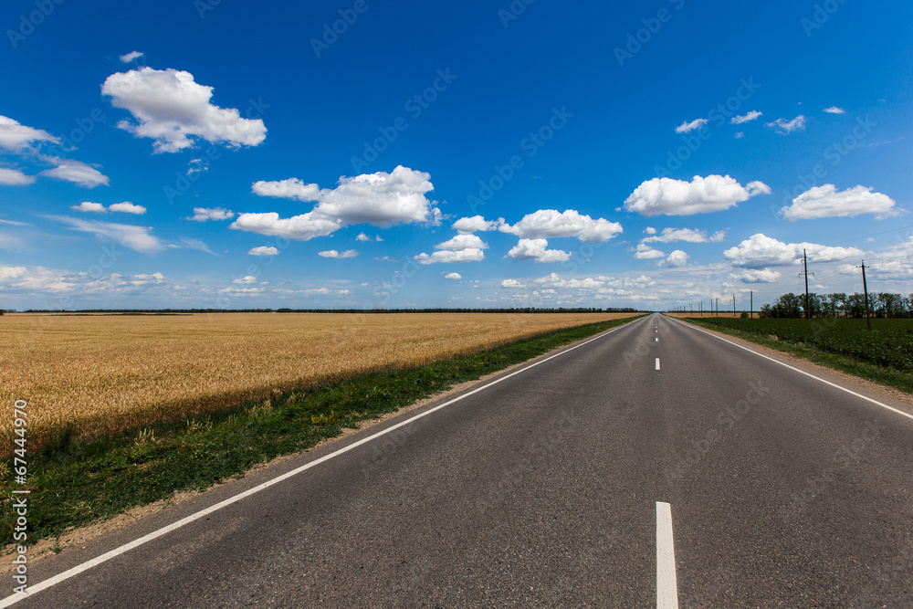 Blue sky with clouds over asphalt road Blue sky with clouds over asphalt road