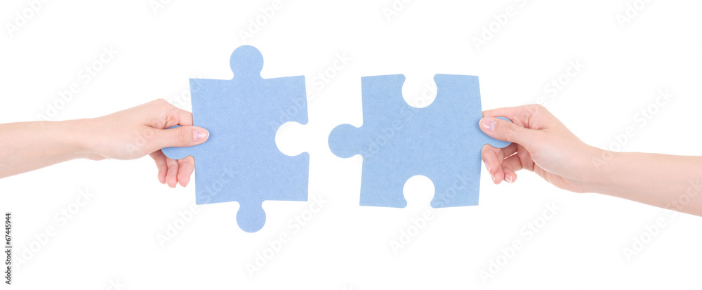 two puzzle pieces in woman hands isolated on white two puzzle pieces in woman hands isolated on white
