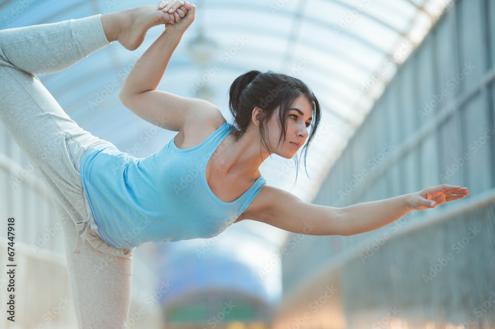 Fototapeta premium Woman Practicing Yoga Outside