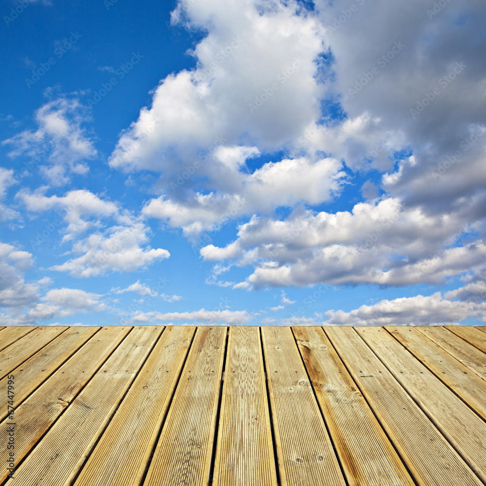 Wooden deck floor and  blue sky