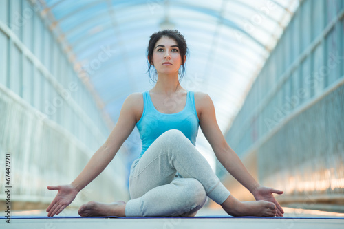Woman doing meditating yoga exercises
