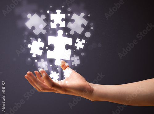 Puzzle pieces in the hand of a businessman