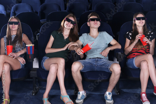 Young people watching movie in cinema