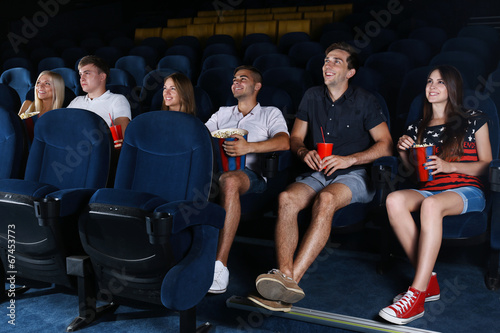 Young people watching movie in cinema