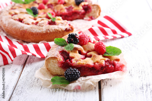 Tasty cake with berries on table close-up