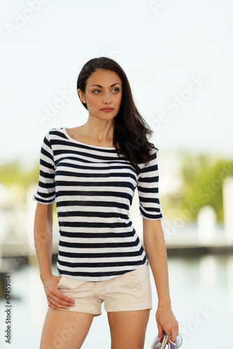 Woman in stripes glancing away from camera Free Download Woman in stripes glancing away from camera - GFXLoad
