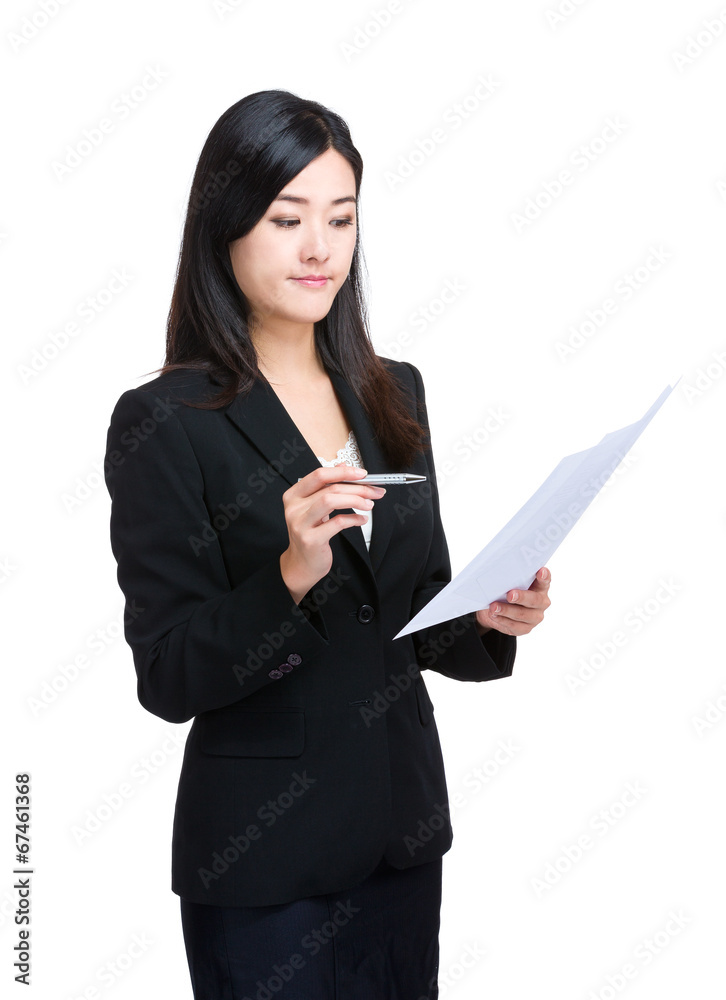 Asian business woman look at information on paper Asian business woman look at information on paper
