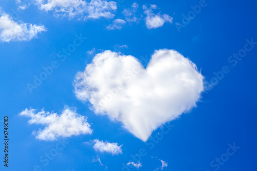 blue sky with a white cloud in the form of heart
