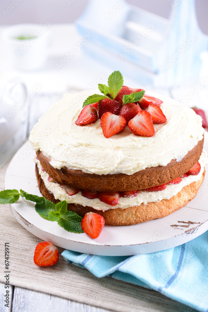 Delicious biscuit cake with strawberries on table close-up Delicious biscuit cake with strawberries on table close-up
