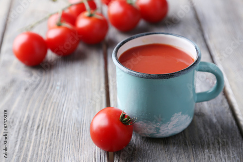 Homemade tomato juice in color mug and fresh tomatoes
