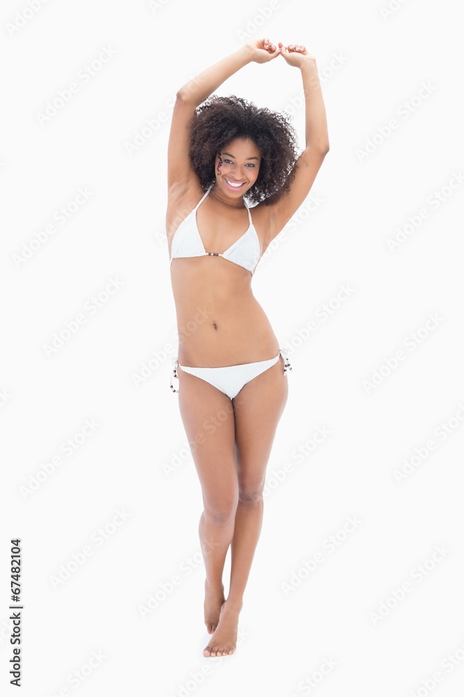 Fototapeta premium Athletic girl in white bikini smiling at camera