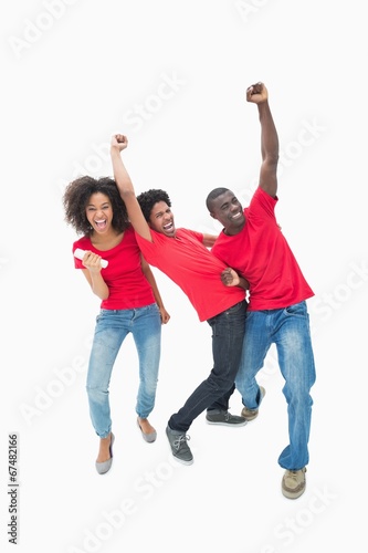 Football fans in red cheering together