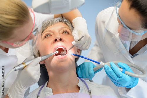 Senior woman patient dental check dentist team