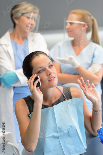 Busy woman patient calling at dentist office