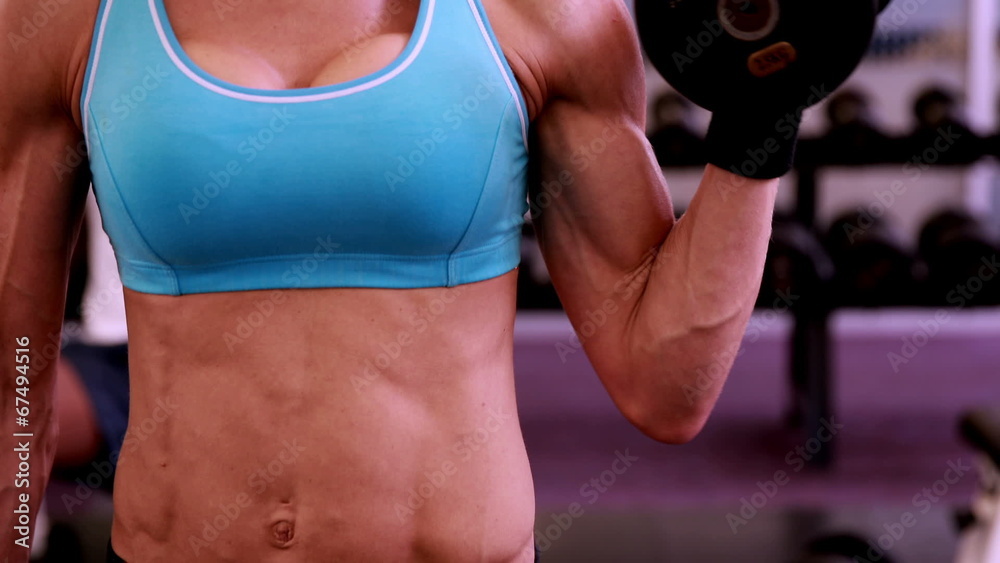 Fit woman lifting dumbbells at crossfit session Fit woman lifting dumbbells at crossfit session