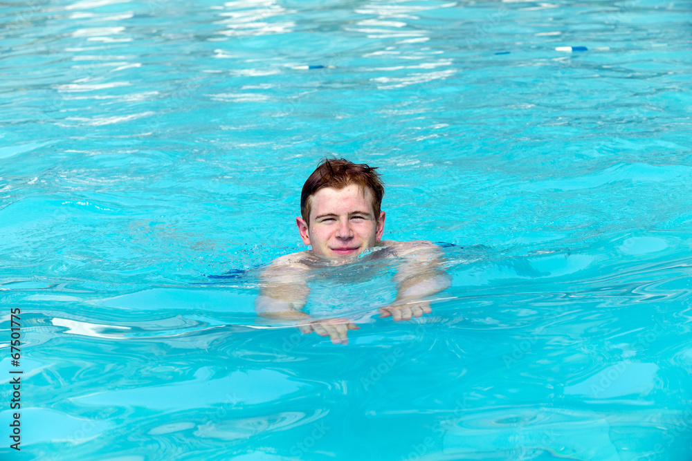 boy has fun swimming in the pool