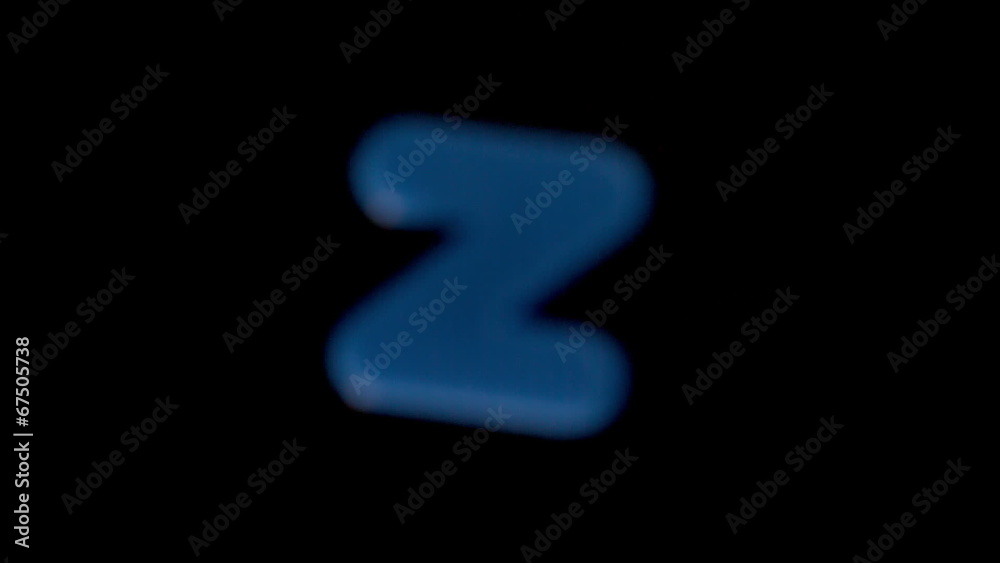 The letter z coming into focus on black background The letter z coming into focus on black background