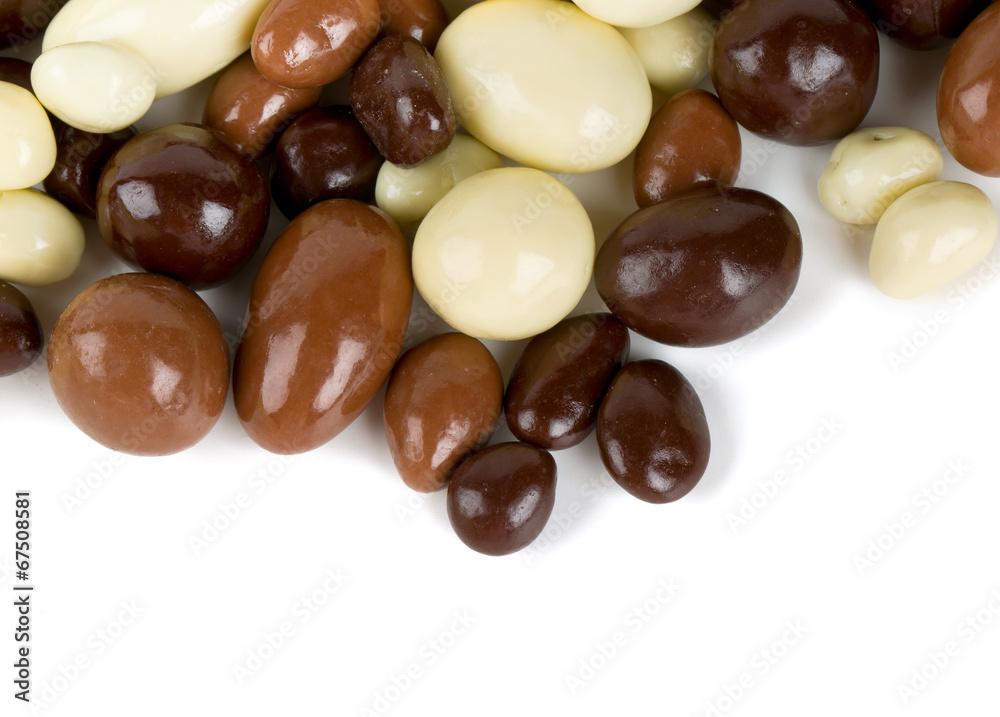 chocolate covered nuts and raisins isolated on white chocolate covered nuts and raisins isolated on white