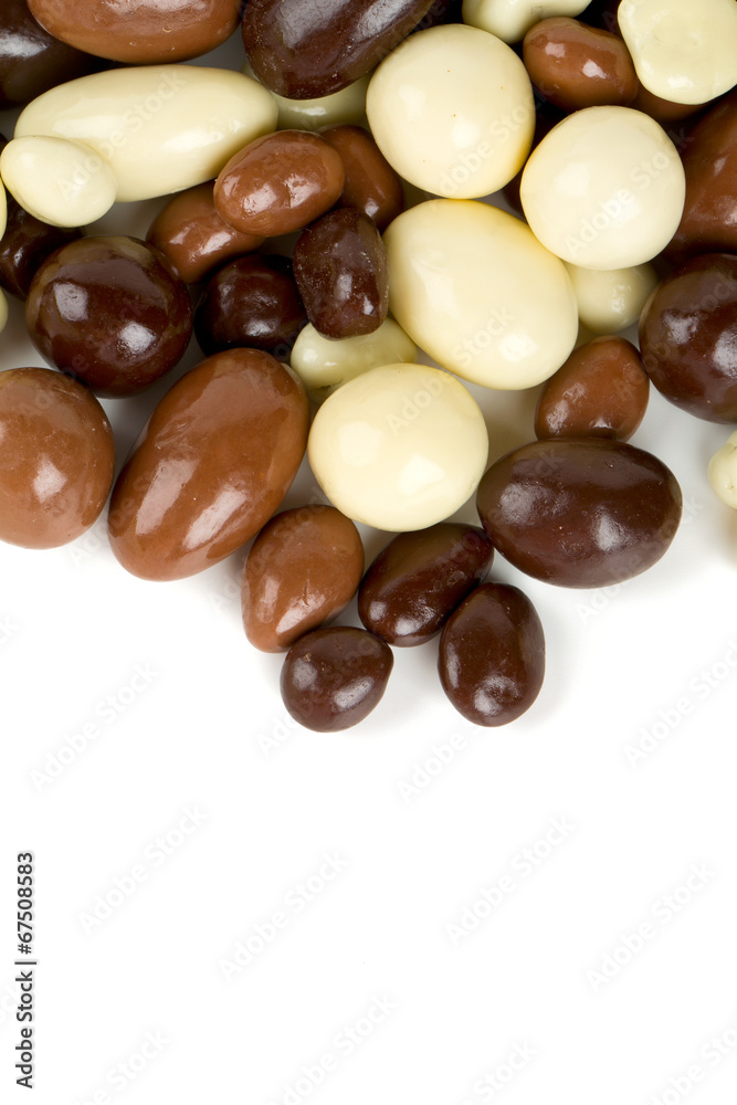 chocolate covered nuts and raisins isolated on white chocolate covered nuts and raisins isolated on white