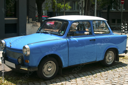 Canvas Print Blue vintage restored Trabant car on paved street