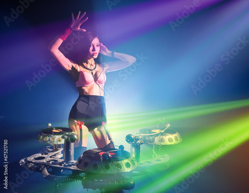 DJ girl in sexy outfit playing on vinyl