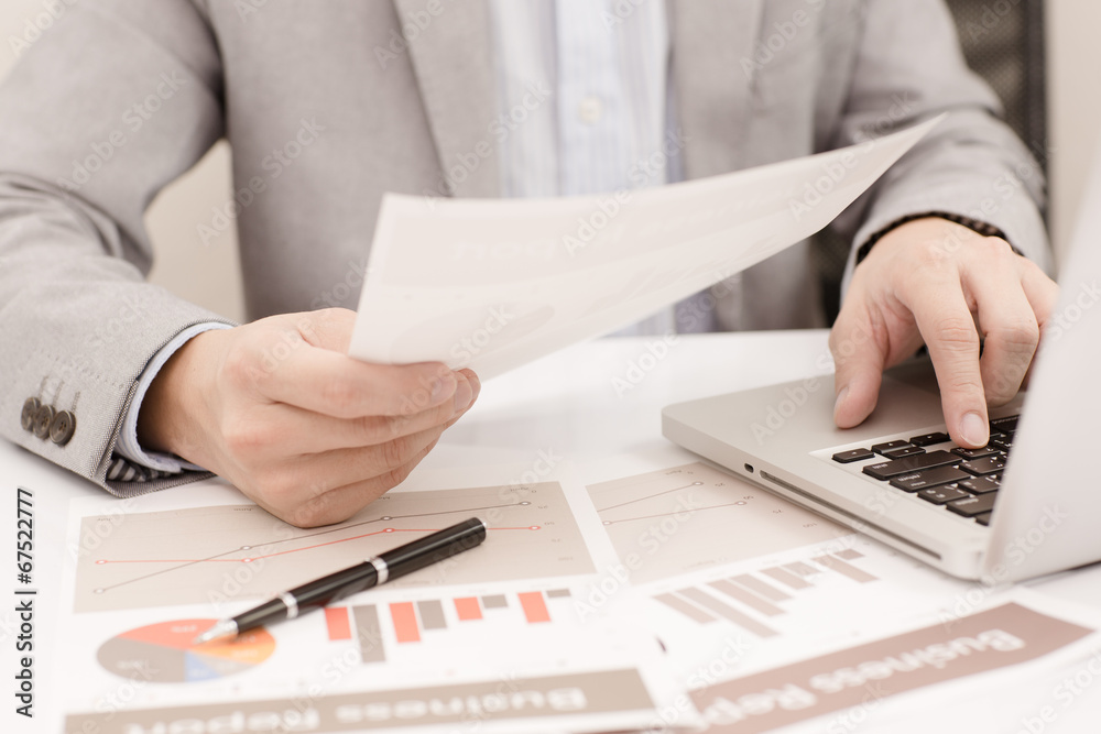 Businessman analyzing investment charts with laptop. Accounting Businessman analyzing investment charts with laptop. Accounting
