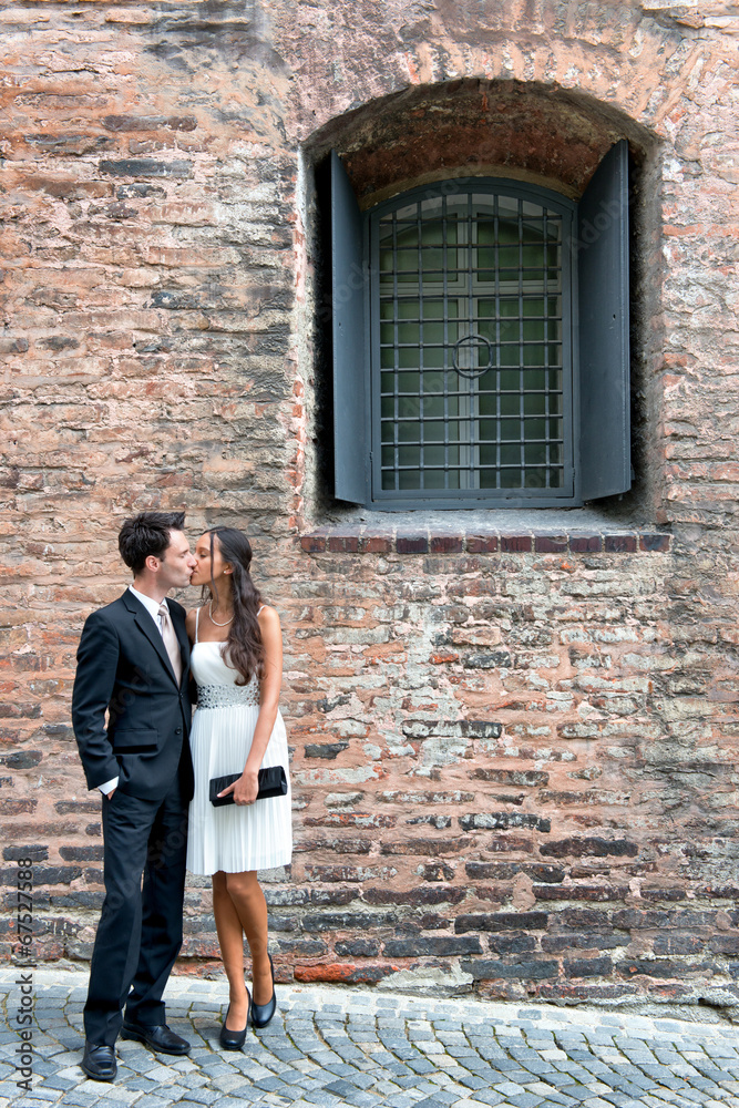 Loving young couple outside an old brick building