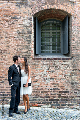 Loving young couple outside an old brick building © XtravaganT