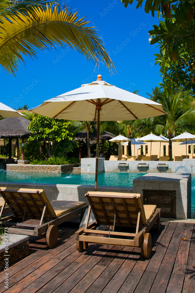 Tropical beach chair next to the pool in Thailand