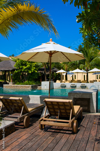 Tropical beach chair next to the pool in Thailand