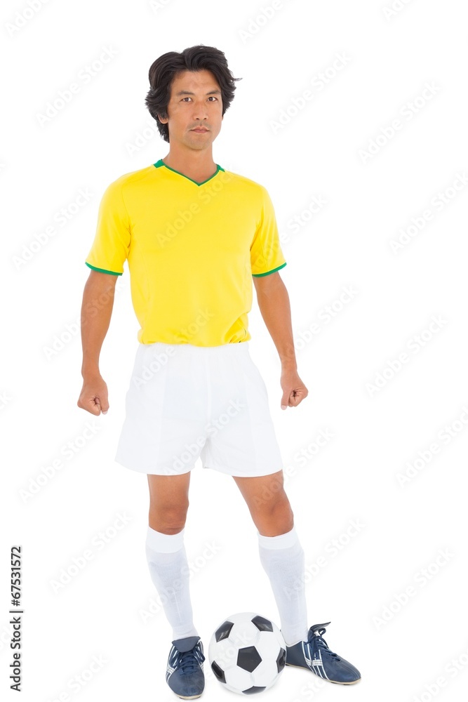 Football player in yellow with ball Football player in yellow with ball