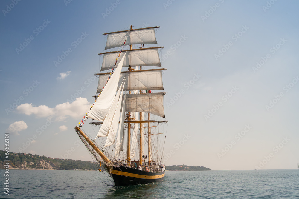 Old ship with white sales, sailing in the sea Old ship with white sales, sailing in the sea