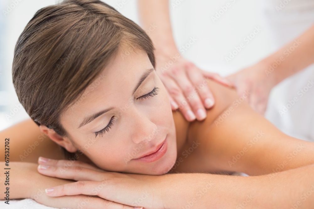 Attractive woman receiving back massage at spa center Attractive woman receiving back massage at spa center