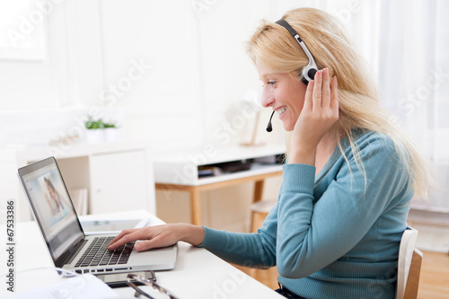 Young attractive woman blonde chatting on laptop