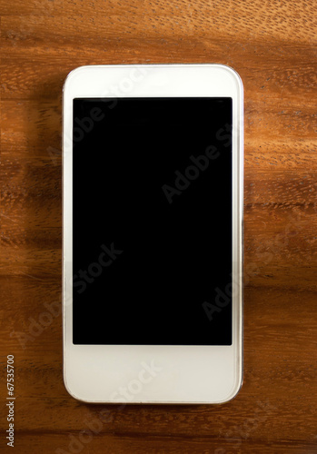 White smartphone on wooden desk