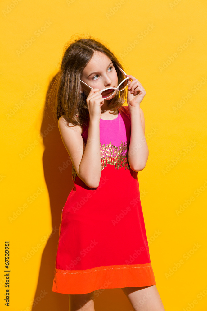 Little fashion model posing with sunglasses Little fashion model posing with sunglasses