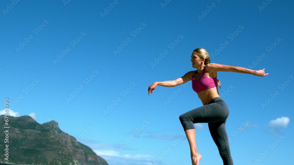 Fit blonde running and jumping on the beach Fit blonde running and jumping on the beach