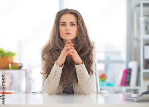 Portrait of thoughtful business woman at work