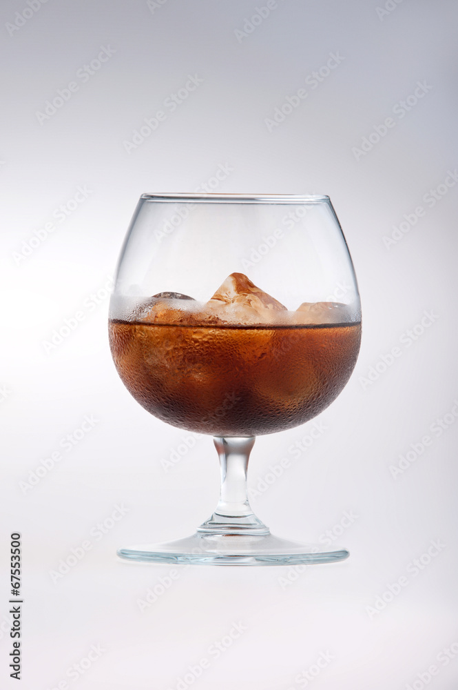 Glass being filled with cola