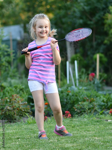 happy little girl playing badminton