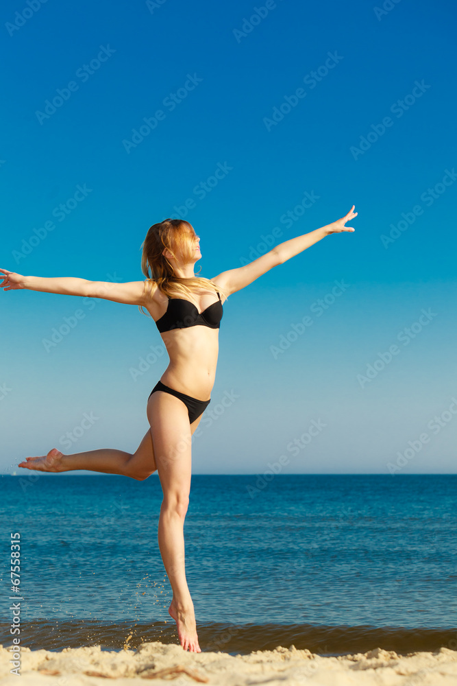 Summer vacation. Girl in bikini running on beach Summer vacation. Girl in bikini running on beach